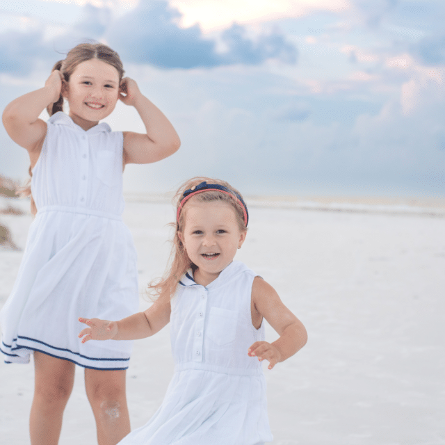 sisters play on the beach at sunrise at longboat key beach by siesta key beach photographer