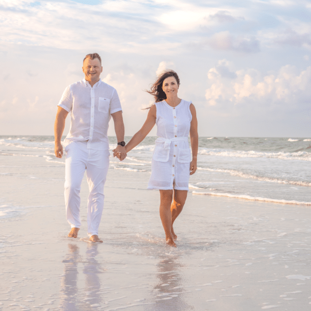 photo of a couple walking on the beach at sunrise in longboat key by longboat key photographer Hinson Photography